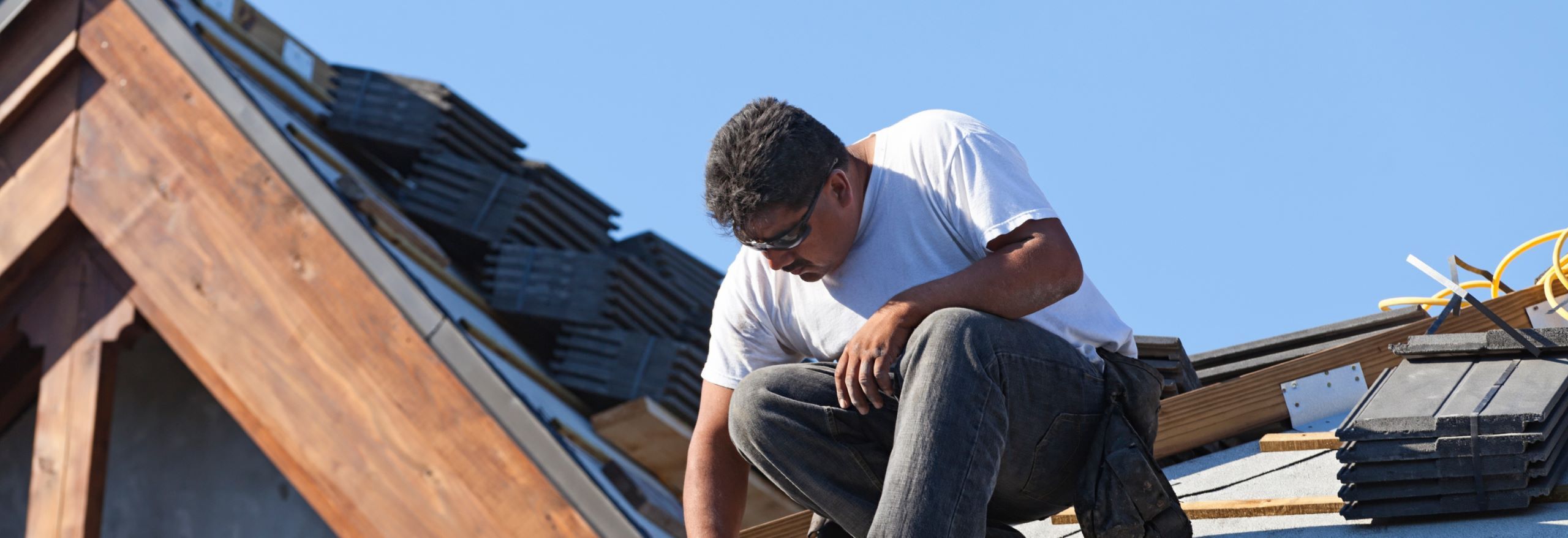A contractor constructing a roof
